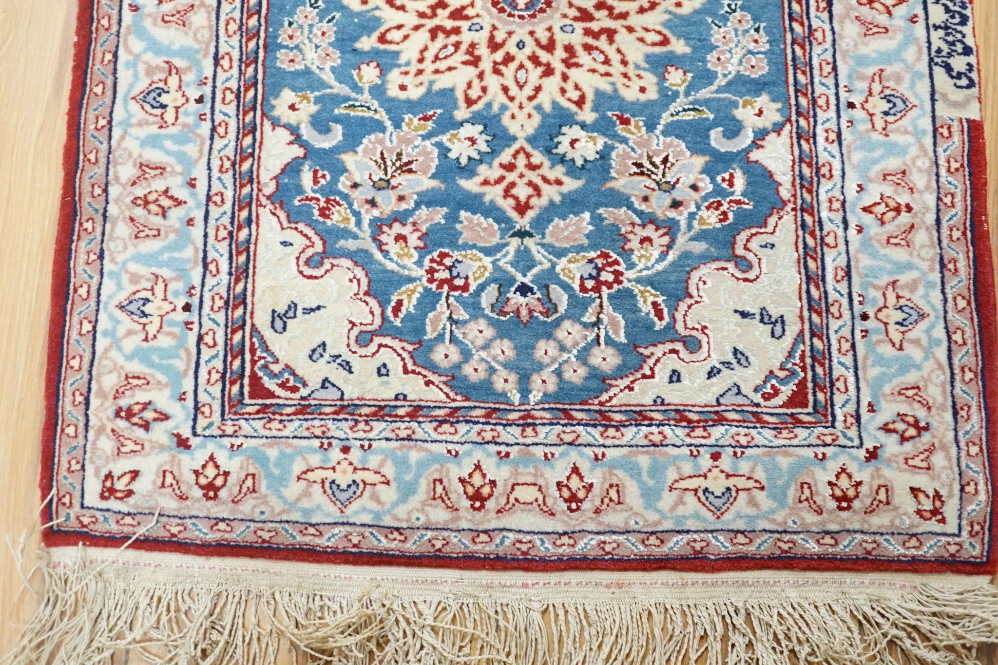 A north-west Persian blue-ground floor mat, signed, 42x53cm